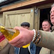 Undated handout photo issued by Blackball Media showing Jeremy Clarkson raffling water outside The Squat Shop, on his farm, Diddly Squat, near Chipping Norton in the Cotswolds which he is running as part of an Amazon Prime show called I Bought A Farm..