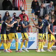 Kyle Joseph is celebrated after scoring his first goal in the win at Exeter. Picture: Darrell Fisher