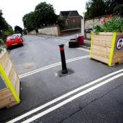 Planters remain at the sides of the roads but the bollards have been removed