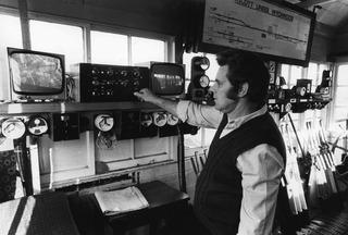 Signalman Ron Huxford is pictured in Ascott-under-Wychwood signalbox in November 1973 with the start of the single line to Oxford shown on the diagram above his head. He is checking the CCTV screen monitoring nearby Bruern level crossing.