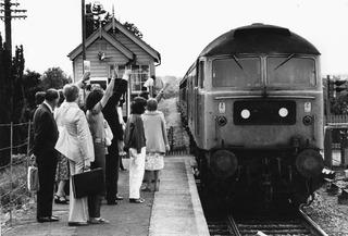 Network Rail is reinstating double track on much of the Cotswold Line between Oxford and Worcester, which was singled in the early 1970s. Passengers flag down a train at Ascott-under-Wychwood's single platform in August 1979.