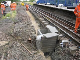 Network Rail is reinstating double track on much of the Cotswold Line rail route between Oxford and Worcester, which was singled in the early 1970s. New drains being installed in the trackbed at Ascott-under-Wychwood station in July 2009.