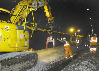 Lifting a section of drain into place in the trackbed at Chipping Campden tunnel, in Gloucestershire, on July 28, 2009