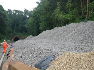 Network Rail is reinstating double track on much of the Cotswold Line. Stone chippings are pictured stockpiled just outside Chipping Campden tunnel for track relaying, July 2009.