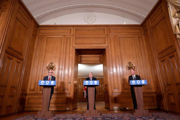 Oxford Mail: Prime Minister Boris Johnson addressed the nation with his chief advisors to announce new restrictions. (Toby Melville/PA)