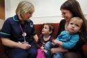 Thank you: Louise Sansom, right, nominated paediatric oncology outreach nurse Zoe Hines for an award last year after her four-year-old daughter Ella Maylor was diagnosed with leukaemia. Louise is holding her other child, son Ethan Maylor, one