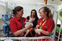 Children's Hospital play specialists Emily Hodgekinson, left, and, Klarissa Burrows with seven-month-old Billy Kearns and his mum Laura..DATE: 26.05.2017..Pic by Jon Lewis......
