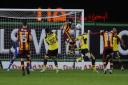 Romain Vincelot (centre) heads in Bradford's stoppage-time equaliser Picture: David Fleming
