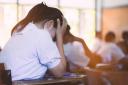 Students taking exam with stress in school classroom.; Shutterstock ID 759633430.