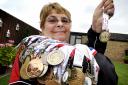 Jill Edwards with the 85 medals she has won taking part in the Transplant Games, including her latest gold medal won last month in Coventry