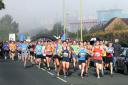 Competitors race away from the Oxford Half Marathon start line outside the mist-shrouded Kassam Stadium. Picture: OX54742 Ric Mellis