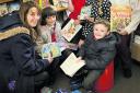READ ALL ABOUT IT: Volunteers Barbara Posner, left, and Gill Shepherd with St Nicholas Primary School pupils Abigail Earl, seven, Samuel Kelsey, six, Maisie Stansfield, six, and Camren Curtis, seven