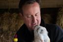 Prime Minister David Cameron helps to feed a newborn lamb at Dean Lane Farm near his Oxfordshire home, having earlier attended an Easter Sunday service in Chadlington with his wife Samantha