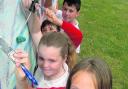 Alicia Higgs, 11, front, and Amberley Castle, 11, behind her, work on the mural