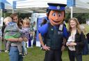 Guests enjoying emergency services day with Policeman mascot