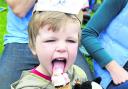 Three-year-old Reuben Cartwright tucks into an ice cream at Saturday’s Teddy Bears’ Picnic on Church Green in Witney