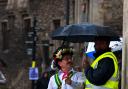 Morris dancer shelters from the rain