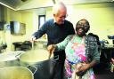 Andrew Bax helps Icolyn Smith prepare food at the soup kitchen
