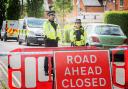 Guard: Police remained on the cordons in Vicarage Road, Didcot, yesterday