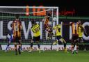 Romain Vincelot (centre) heads in Bradford's stoppage-time equaliser Picture: David Fleming