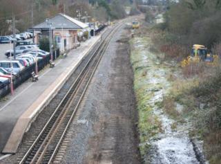 Signs of preparations for the laying of the second track through Charlbury station on December 17, 2010, with old stone ballast removed where the new rails will run. A new platform will be built on the right