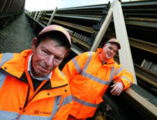 Railway workers John McClafferty, left, and Paul Evans alongside a train loaded with rails at Hinksey Sidings in Oxford on December 17, 2010.