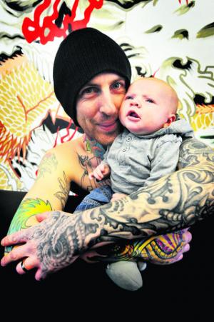 Tattoo artist Paul Humphreys with baby son Presley-Ray