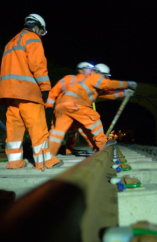 Adjusting track clips to ensure rails are held firmly in place on sleepers at Moreton-in-Marsh, Gloucestershire