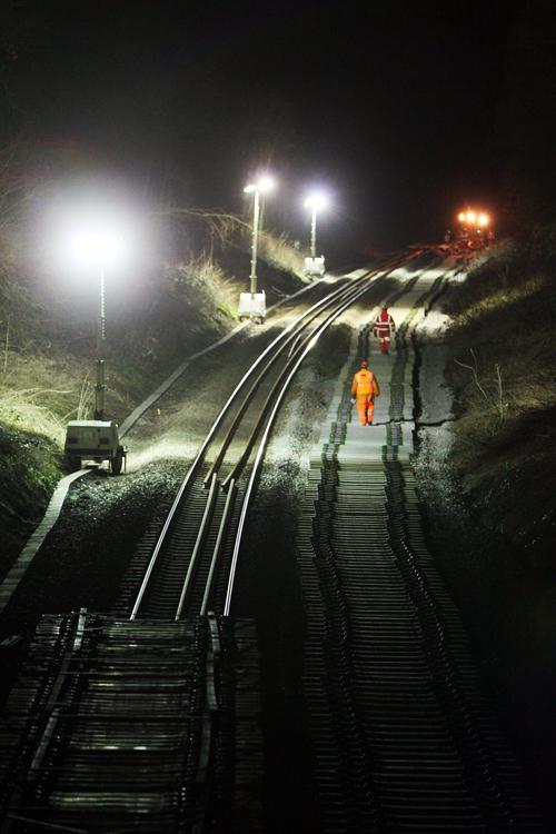 Floodlights illuminate Dorn cutting, near Moreton-in-Marsh, in Gloucestershire, as engineers prepare to unload 1,300 sleepers for half-a-mile of new track on the Cotswold Line