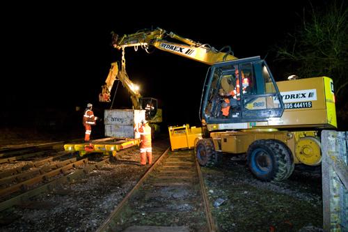 Loading equipment on to a trailer at Moreton-in-Marsh station to move it to a work site ahead of another night's tracklaying on the Cotswold Line redoubling project