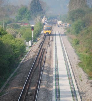 A First Great Western Turbo train passes newly-laid sleepers on the approach to Ascott-under-Wychwood on April 20, 2011