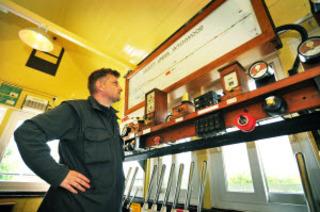 Duty signaller Gerry Kane checks the signal instruments at Ascott-under-Wychwood signalbox on Wednesday, May 18, 2011
