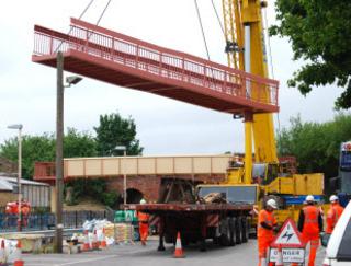 The first section of the access ramps on the new footbridge at Charlbury station is lifted over the line on Sunday, May 29, 2011.
