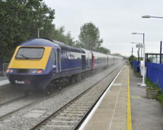 Dust from the new track is thrown up as an express speeds through Ascott-under-Wychwood station on Monday, June 6, 2011