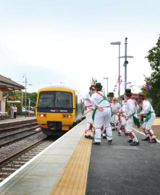 Charlbury morris men greet a train from Oxford during celebrations of the redoubling of the Cotswold Line at the town's station on Friday, June 10, 2011