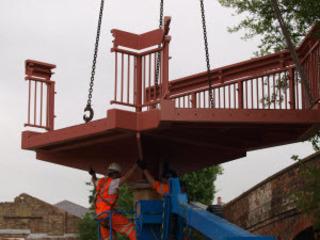 Fixing a landing in place on the new footbridge at Charlbury station