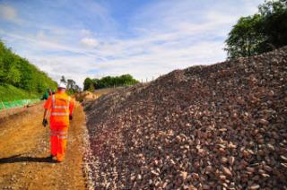 Stone stockpiled ready to form the new trackbed close to the Cornbury Park bridge at Charlbury