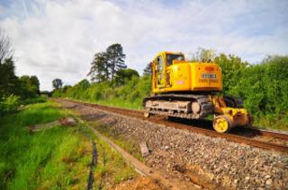 A road-rail excavator waits for its next job near the Cornbury Park bridge at Charlbury
