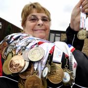 Jill Edwards with the 85 medals she has won taking part in the Transplant Games, including her latest gold medal won last month in Coventry