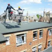 Oxfordshire firefighters use a hydraulic platform to try to rescue a pigeon from behind Boswells on Broad Street, May 1, 2009. Picture: Andy Eddy