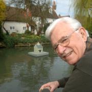 Brian Eastoe with the duck house on the pond in Drayton