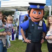 Guests enjoying emergency services day with Policeman mascot