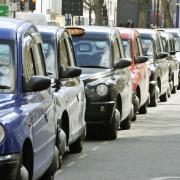 A black cab rushed past a cyclist