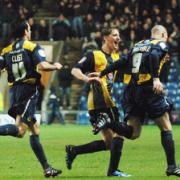 James Constable races to celebrate with the Oxford United bench after hitting the winner against Barnet on Saturday