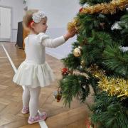 A girl looking at decorations on a Christmas tree. Photo: Kimberley-Jane Day