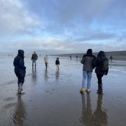 A family walk on the beach. Photo: Donna Cassettari
