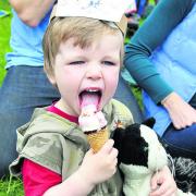 Three-year-old Reuben Cartwright tucks into an ice cream at Saturday’s Teddy Bears’ Picnic on Church Green in Witney
