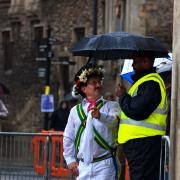 Morris dancer shelters from the rain