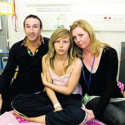Maisie with her parents at Oxford Children's Hospital