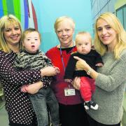 Rowena Pearce, centre, advanced nurse practitioner for children with disability, pictured with, left, Nina Lawson and Jon-Paul, four, and Nicole Marsh and James, eight months. Picture: OX63442 Antony Moore